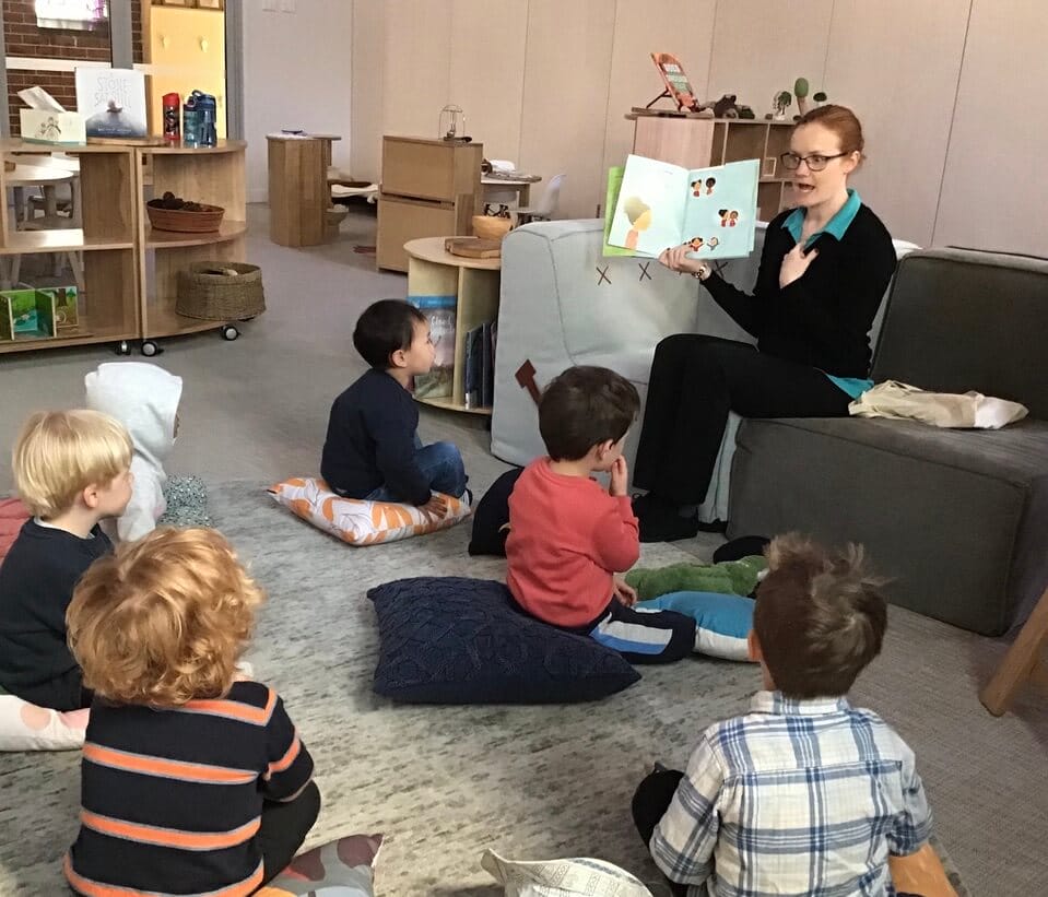 SEEC leader reads to preschool children at the service
